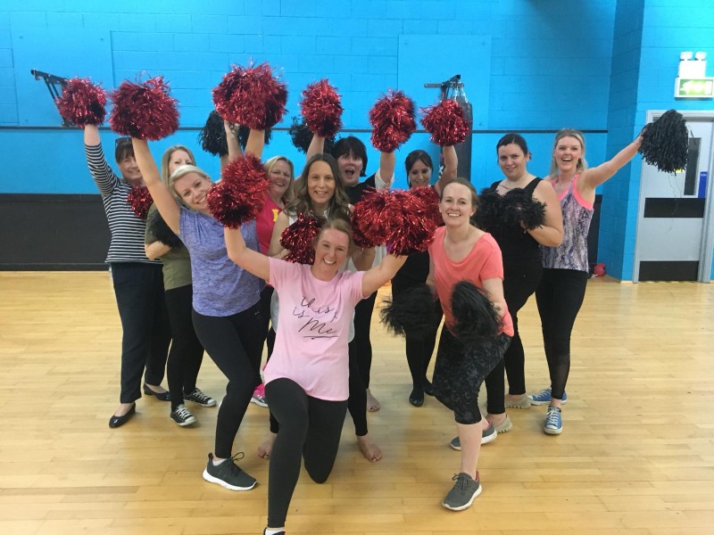 Group of hens with pom-poms performing cheerleading routine at York Dance Centre studio